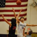 Hayden Eaton, 50, fights for the opening tipoff of the Sequim Wolves game against the Port Townsend Redhawks on Dec. 9, which the Wolves ultimately won 67-55. Sequim Gazette photo by Conor Dowley