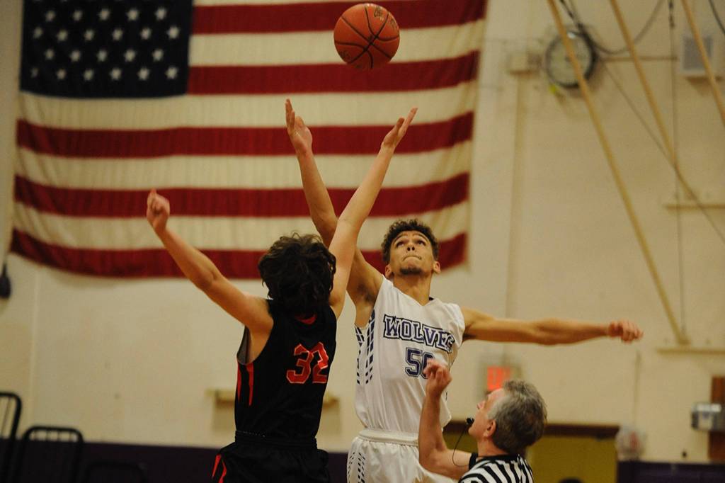 Hayden Eaton, 50, fights for the opening tipoff of the Sequim Wolves game against the Port Townsend Redhawks on Dec. 9, which the Wolves ultimately won 67-55. Sequim Gazette photo by Conor Dowley