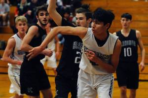 Sequim Wolves freshman forward Isaiah Moore, pictured second from right playing against the Klahowya Eagles on Dec. 2, scored 45 points with 32 rebounds and 6 blocks in his first four games of the season. Sequim Gazette photo by Conor Dowley