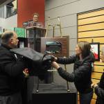 Robb Reese reveals a plaque at the dedication of the Karen Kuznek-Reese Gallery at the Sequim Civic Center on Dec. 6. Kuznek-Reese, a long-time city clerk and arts advocate, died on Nov. 14. Looking are, from left, Sharon Delabarre of Sequims City Arts Advisory Commission (in back) and Kuznek-Reeses daughter Alicia Neal and mother Helen. Sequim Gazette photo by Michael Dashiell