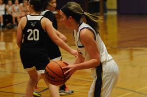 Kalli Wiker, right, pictured playing against the Klahowya Eagles on Dec. 2, set the Sequim High School record for 3-pointers made during a girls basketball game with eight, and tied the overall school record set by Art Green. Sequim Gazette photo by Conor Dowley