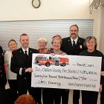 Representatives with Clallam County Fire District 3 and the Sequim-Dungeness Hospital Guild stand together to pass along a donation to the fire department for various emergency medical services training on Dec. 12 in St. Lukes Episcopal Church. Included in the presentation, are from left, Assistant Fire Chief Tony Hudson, Suzi Schmidt, Capt. Derrell Sharp, Wanda Bean, Nancy McGovern, president of the guild, Fire Chief Ben Andrews, Pauline Valha, and Debbie Kahle. Sequim Gazette photo by Matthew Nash