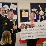 Using a donation from the Sequim-Dungeness Hospital Guild, Capt. Derrell Sharp with Clallam County Fire District 3 told a crowd of guild members on Dec. 12 in St. Lukes Episcopal Church that funds will support training for paramedics/EMTs and the public throughout 2020. Guild President Nancy McGovern and other board members presented the check to Sharp and Fire Chief Ben Andrews and other fire district leaders. Sequim Gazette photo by Matthew Nash