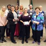 Pictured, from left, are: chief nursing officer Ralph Parker; clinic manager-primary care and pediatric Lacey Gentry, director of medical/surgical/pediatrics Robin Burse, Patty Stewart-Ford, Lea Sollmann, Karen Bennett, Karen Reeder, Michael Perchert-Osuna, Judy Bedford, director of ICU/telemetry Katrin Junghanns-Royack, and OMC chief executive officer Eric Lewis, chief executive officer. Not pictured are Katie Sayles and Kaylee Sullivan. Photo courtesy of Olympic Medical Center