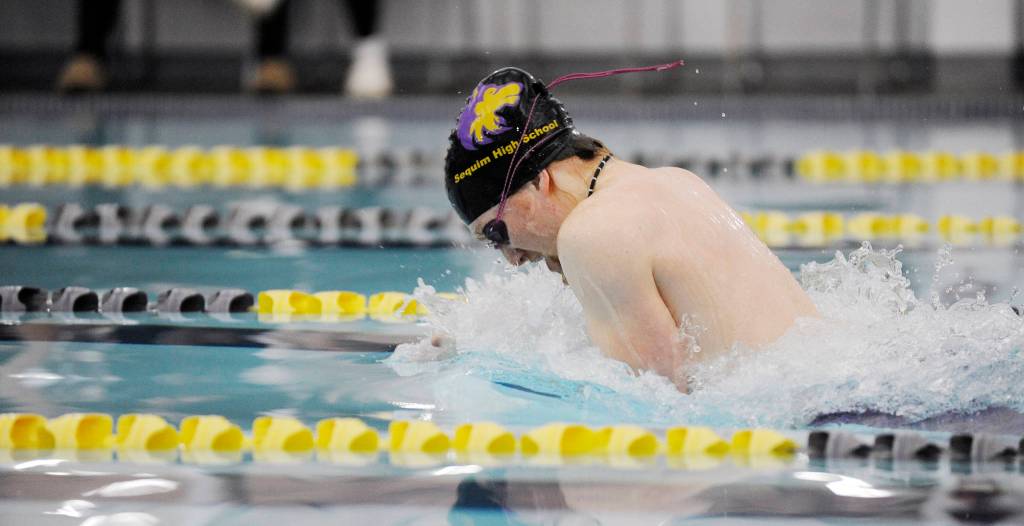 Sequims Jesse Bobst swims to a win in the 100 breaststroke in a Dec. 19 league meet in Sequim against rival Port Angeles. Sequim Gazette photo by Michael Dashiell
