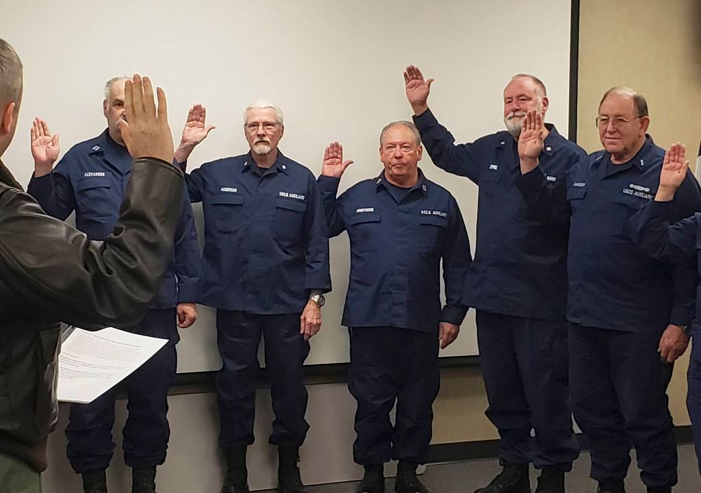 Cmdr. M. Scott Jackson, commanding officer of Coast Guard Air Station/Sector Field Office Port Angeles, administers the oath of office to Coast Guard Auxiliary staff officers for 2020 from District 13, Division 4 during a meeting at the air station on Saturday, Dec. 14. Richard Halsaver of Sequim will be division commander and Thomas Bliss of Gig Harbor becomes division vice commander. From left, Jackson, Auxiliary members Dean Alexander, Brian Anderson, James Armstrong, Randall Zempel and Robert Hancock. Photo by Auxiliarist Drew Herman