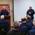 Members at the 2019 USCG Auxiliary District 13, Division 4 listen in as incoming USCG District 13 Commodore Tiney Singler addresses attendees. Sequims Dick Halsaver, incoming Auxiliary division commander, watches from the podium. Photo by Auxiliarist James McLaughlin