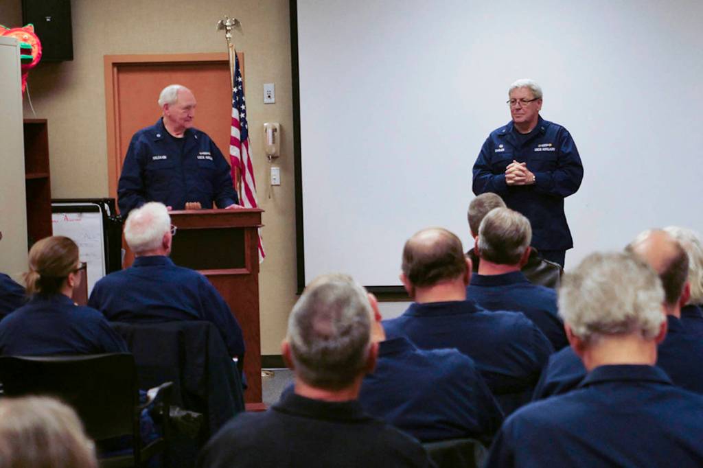 Members at the 2019 USCG Auxiliary District 13, Division 4 listen in as incoming USCG District 13 Commodore Tiney Singler addresses attendees. Sequims Dick Halsaver, incoming Auxiliary division commander, watches from the podium. Photo by Auxiliarist James McLaughlin