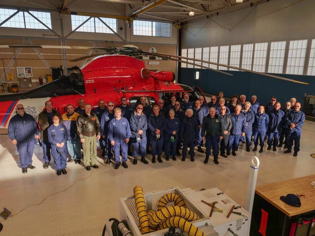 Cmdr. Scott Jackson (in leather flight jacket on the left), commanding officer of Sector Port Angeles, joins members and guests of the 2019 USCG Auxiliary District 13 Division 4 meeting held at USCG Station Port Angeles on Dec. 14. Photo by Auxiliarist James McLaughlin