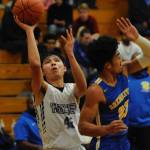Isaiah Moore (42) shoots from the baseline past Bremerton Knights forward Kaipo Raitome (22) during the second quarter of the Sequim Wolves game against the Knights on Dec. 17. Despite Moores a season-high 26 points, the Wolves lost 77-62. Sequim Gazette photos by Conor Dowley