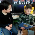 Fifth-grader Noah Andrzejeski, right, reads a book to 
first-grader Dmarko Green.                                 From left, fifth-graders Leila Sanderson and Lucy Vincent read to first-grader Eulalia Gonzalez. Photos by Patsene Dashiell