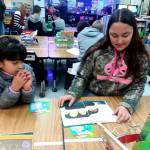 Fifth-grader Elizabeth Howard, right, reads with first-grader Camila Lopez. Photo by Patsene Dashiell