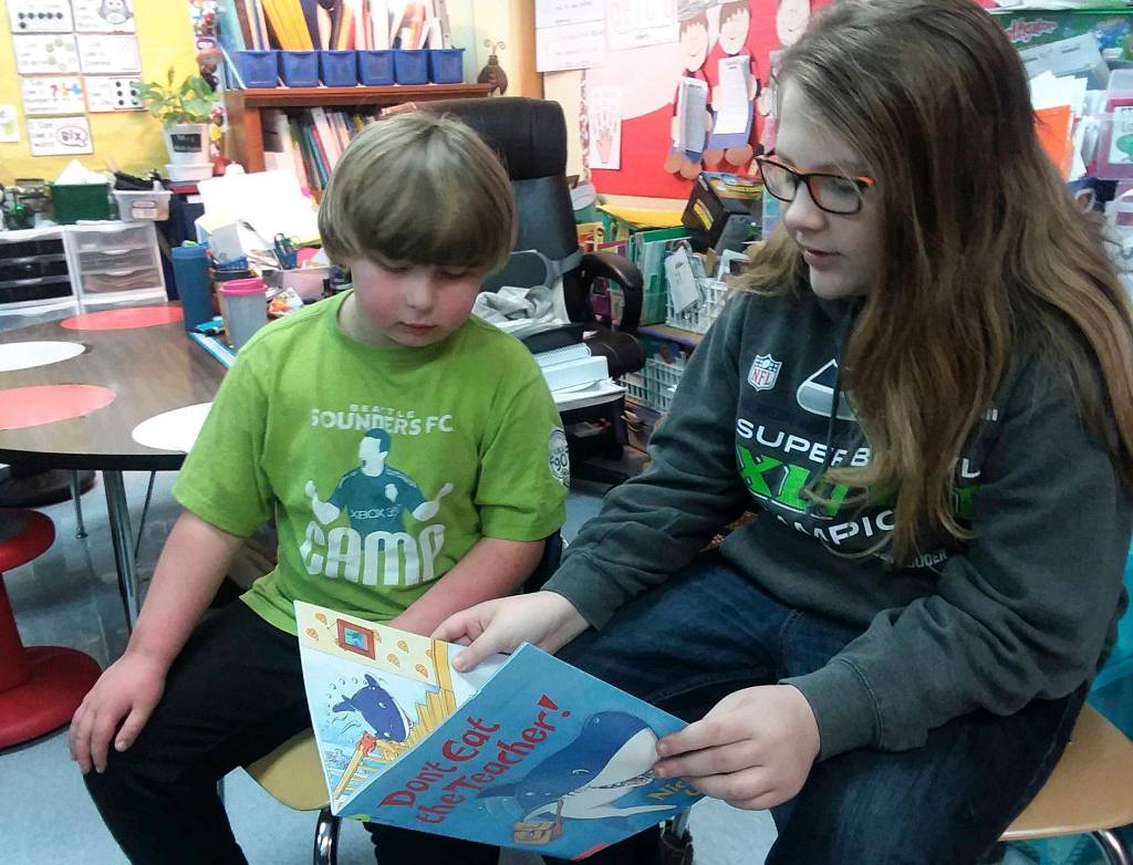 Fifth-grader Clinton Cosio, right, reads with first-grader Dusty Jenkins. Photo by Patsene Dashiell