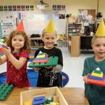 Kindergarteners (from left) Amelia Moose, Atticus Reed and Wesley Priest use interlocking blocks to create 3-D triangles during a shape fair in Lorrie Corders classroom at Helen Haller Elementary School.