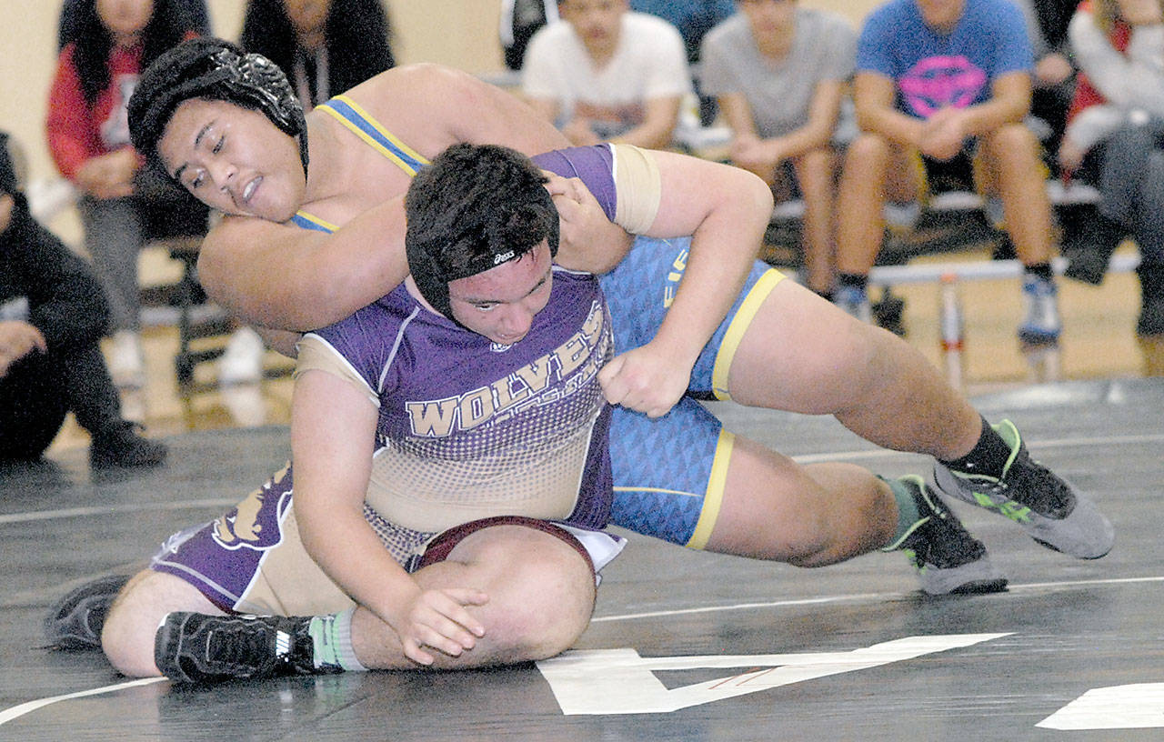 Caleb Nuu of Fife, top, wrestles with Sequims Bodi Sanderson in the 285-lb. weight class on Jan. 4 at Port Angeles High School. Photo by Keith Thorpe/Olympic Peninsula News Group
