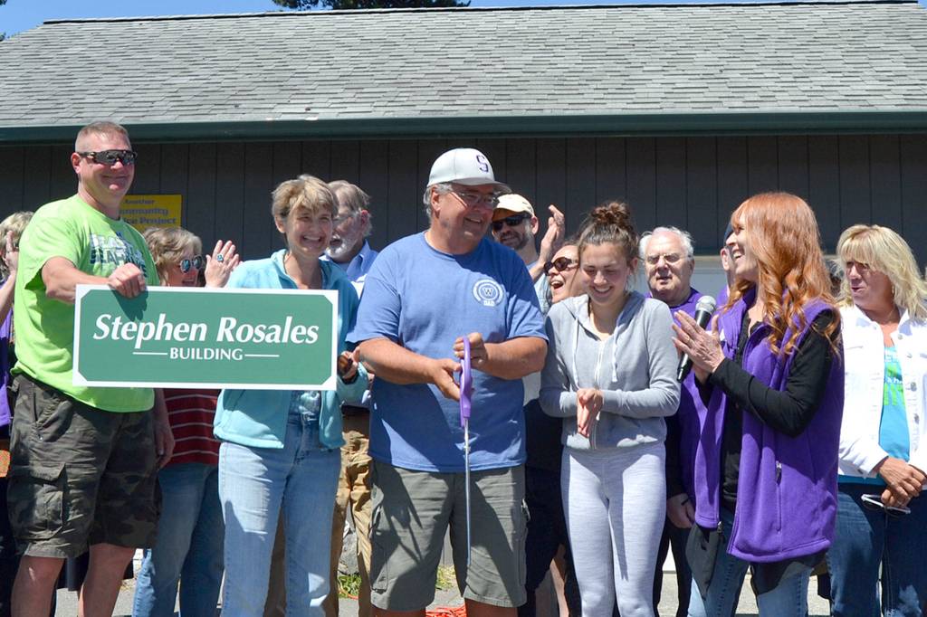 Along with his family and friends with the Sequim-Dungeness Valley Chamber of Commerce, Stephen Rosales cuts the ribbon for the bread and meat building at the Sequim Food Bank that was named after him on June 15. Sequim Gazette file photo by Matthew Nash