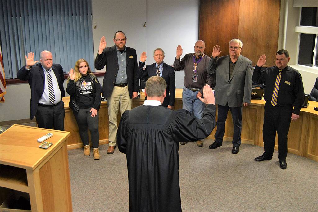 Clallam County Superior Court Judge Brent Basden swears in new and existing staff and board members for 2020 on Dec. 2  including, from top left, interim superintendent Rob Clark, student liaison Olivia Preston, Brian Kuh, Brandino Gibson, Jim Stoffer, Larry Jeffryes and Eric Pickens. Sequim Gazette file photo by Matthew Nash