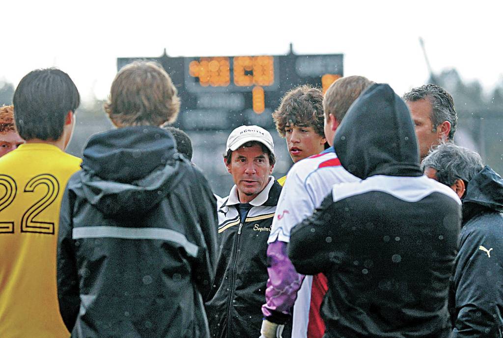 Sequim High head coach Dave Brasher, center, talks to his players in a sub-district playoff game in 2011 against Eatonville (Sequim won in overtime). Brasher stepped down from his position in 2019 after 24 years leading the varsity program. Sequim Gazette file file photo by Michael Dashiell