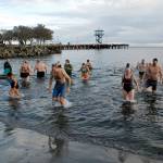 Polar bear dippers wade ashore at Hollywood Beach in Port Angeles after the first of three plunges into Port Angeles Harbor on New Years Day. Photo by Keith Thorpe/Olympic Peninsula News Group