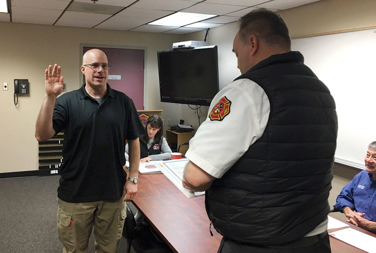 Newly-selected Fire District 3 commissioner Bill Miano, left, is sworn in to office by District 3 Fire Chief Ben Andrews on Jan. 7. Miano replaces James Barnfather, who had served two six-year commissioner terms and ran for re-election in November. Commissioner Mike Gawley was voted in as chairman while Steve Chinn remains the boards vice-chair. Commissioners will consider a resolution at their Jan. 21 meeting considering if Miano can remain a firefighter volunteer while on the commission. Sequim Gazette photo by Matthew Nash