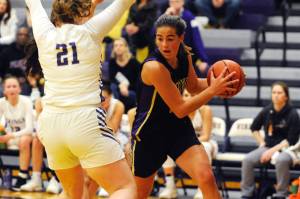Hope Glasser (right) drives into the lane against North Kitsap Vikings forward Georgia Tucker in the second quarter of the Sequim Wolves 55-45 win over the Vikings on Jan. 7. Glasser and teammate Kalli Wiker lead the scoring for the Wolves with 12 points apiece, and Glasser helped keep the Wolves in the game during a back-and-forth first half.