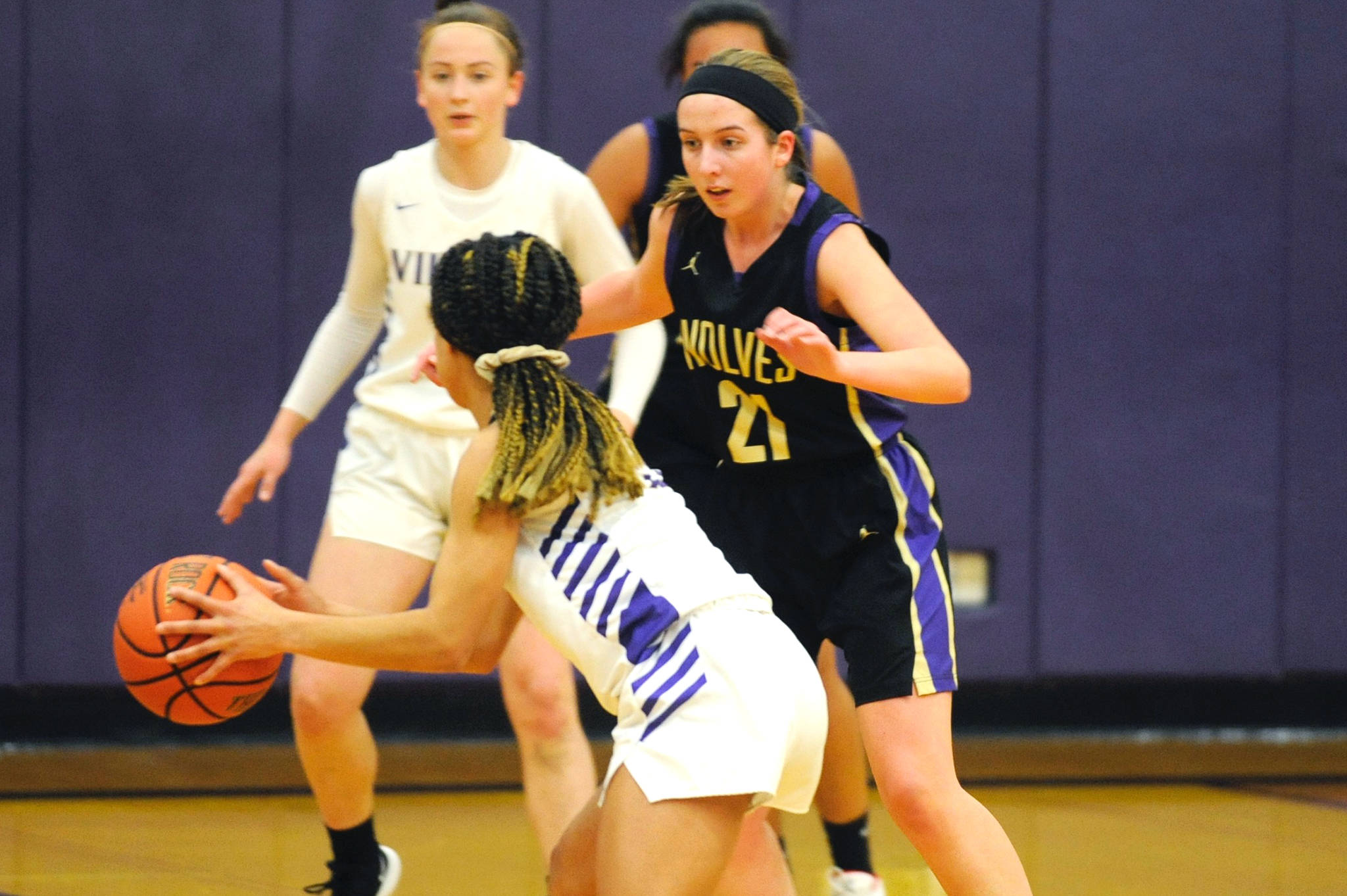 Kalli Wiker (21) guards North Kitsap Vikings guard Kamora McMillian during the first quarter of the Sequim Wolves 55-45 win over the Vikings on Jan. 7. Wiker and teammate Hope Glasser lead the team with 12 points apiece, with Wiker scoring all 12 of her points in the second half to help the Wolves pull away after a close first half. Sequim Gazette photo by Conor Dowley