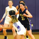 Kalli Wiker (21) guards North Kitsap Vikings guard Kamora McMillian during the first quarter of the Sequim Wolves 55-45 win over the Vikings on Jan. 7. Wiker and teammate Hope Glasser lead the team with 12 points apiece, with Wiker scoring all 12 of her points in the second half to help the Wolves pull away after a close first half. Sequim Gazette photo by Conor Dowley