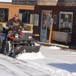 David Silliman of Simply Beautiful Builders clears the parking lot at 213 E. Washington St. with his ATV-mounted snowplow on Jan. 14. I can get into a lot of places other plows cant, Silliman joked. Snowfall on Jan. 15 canceled and postponed a number of community events and forced closure of Sequim schools. Sequim Gazette photo by Conor Dowley