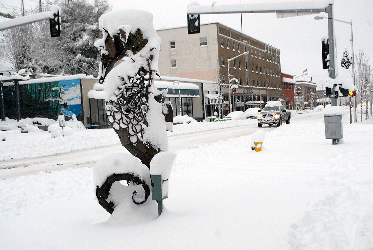 The Seahorse sculpture at First and Laurel streets stands with a drape of snow Wednesday morning in downtown Port Angeles. Photo by Keith Thorpe/Olympic Peninsula News Group