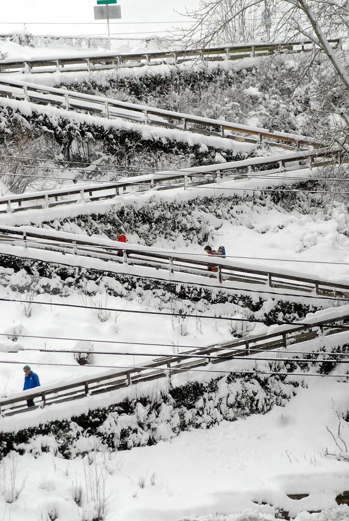 People navigate the snow-covered zig-zag ramp at Oak Street in downtown Port Angeles on Wednesday. Photo by Keith Thorpe/Olympic Peninsula News Group