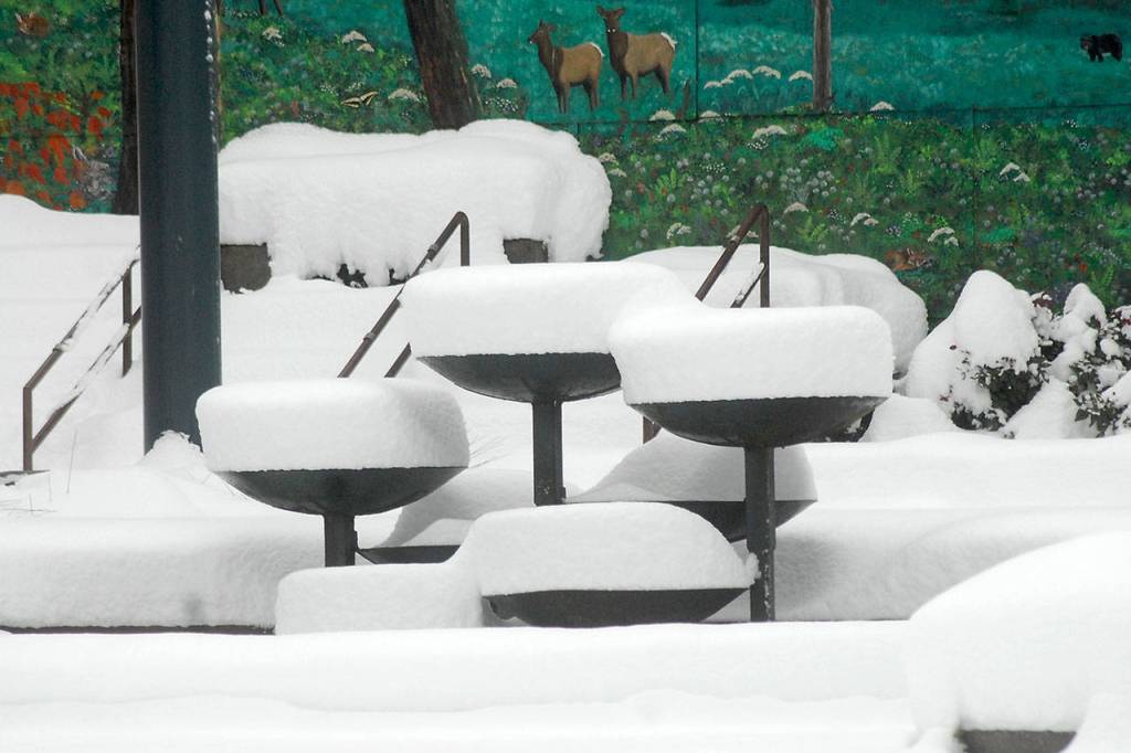 A mantle of snow buries the Conrad Dyar Memorial Fountain on Wednesday morning in downtown Port Angeles. Photo by Keith Thorpe/Olympic Peninsula News Group