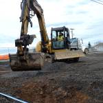 Work continued on Monday along West Fir Street after snow delayed Interwest Construction for a week. Here, crewmen cover irrigation pipeline at the Second Avenue and Fir Street intersection. Sequim Gazette photo by Matthew Nash