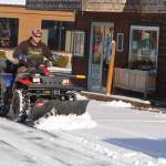 David Silliman of Simply Beautiful Builders clears the parking lot at 213 E. Washington St. with his ATV-mounted snowplow on Jan. 14. I can get into a lot of places other plows cant, Silliman joked. Sequim Gazette photo by Conor Dowley