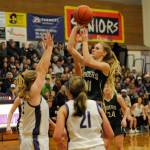 Port Angeles Millie Long, right, puts up a shot over the Sequim defense in the Roughriders 64-42 win at Sequim on Jan. 18. Long had 12 points. Sequim Gazette photo by Michael Dashiell