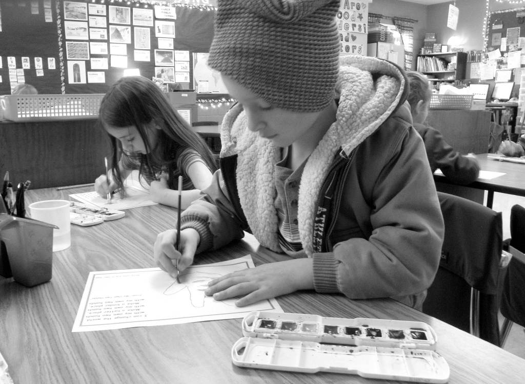 Wyatt Estep, right, and MaKenzie Hadley use watercolors to paint their hand traces.