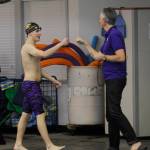SHS senior Rane Forcinel gets a fist-bump from coach Britt Hemphill after a strong swim in the 50 free against Klahowya on Jan. 23. Sequim Gazette photo by Michael Dashiell