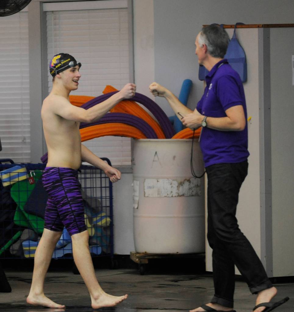 SHS senior Rane Forcinel gets a fist-bump from coach Britt Hemphill after a strong swim in the 50 free against Klahowya on Jan. 23. Sequim Gazette photo by Michael Dashiell