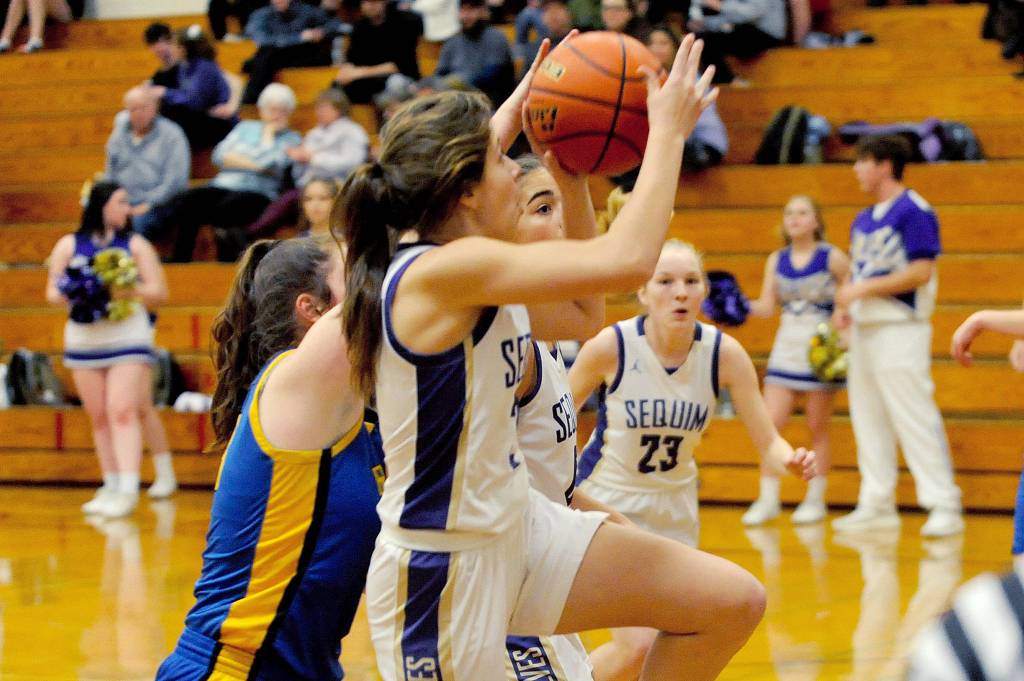 Jessia Dietzman gets fouled while taking a running shot in the first quarter of the Wolves 85-16 win over the Bremerton Knights on Jan. 24. Dietzman scored 10 points and added four assists and three steals. Sequim Gazette photo by Conor Dowley