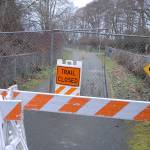 Barricades, construction fencing and a warning sign block a section of the Olympic Discovery Trail near Four Seasons Ranch east of Port Angeles near the site where human remains were discovered near a storm-damaged portion of the trail. Photo by Keith Thorpe/Olympic Peninsula News Group