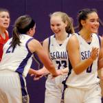 Kalli Wiker, Melissa Porter, and Hope Glasser (left to right) celebrate after the final buzzer of the Sequim Wolves 60-52 win over the Kings Knights on Jan. 29.