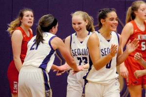 Kalli Wiker, Melissa Porter, and Hope Glasser (left to right) celebrate after the final buzzer of the Sequim Wolves 60-52 win over the Kings Knights on Jan. 29.