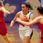 Sequim Wolves post Hope Glasser (center) drives inside against two Kings Knights defenders during the fourth quarter of the Wolves 60-52 win over the Knights on Jan. 29. Hope scored 10 points on the night, along with five assists, two steals and a block.