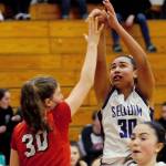 Sequim Wolves post Jayla Julmist (30, center) pulls back and takes a shot after stealing the ball and running up the court on a fast break in the second quarter of the Wolves 60-52 win over the Kings Knights on Jan. 29. Julmist made her return from a knee injury, scoring seven points with eight rebounds, three blocks and two steals. Sequim Gazette photo by Conor Dowley