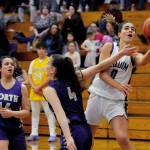 Sequim Wolves guard Hannah Bates (right) drives inside against North Kitsap Vikings guard Kamora McMillian during the second quarter of the Wolves 78-49 win over the Vikings on Jan. 31. Bates scored 16 points off the bench, and Wolves head coach Linsay Rapelje remarked after the game she was playing so well it was hard to take her off the court. Sequim Gazette photo by Conor Dowley                                Sequim Wolves post Hope Glasser (0) gets fouled by North Kitsap Vikings guard Sophia Baugh while shooting on a drive into the lane during the second quarter of the Wolves 78-49 win over the Vikings on Jan. 31. Sequim Gazette photo by Conor Dowley