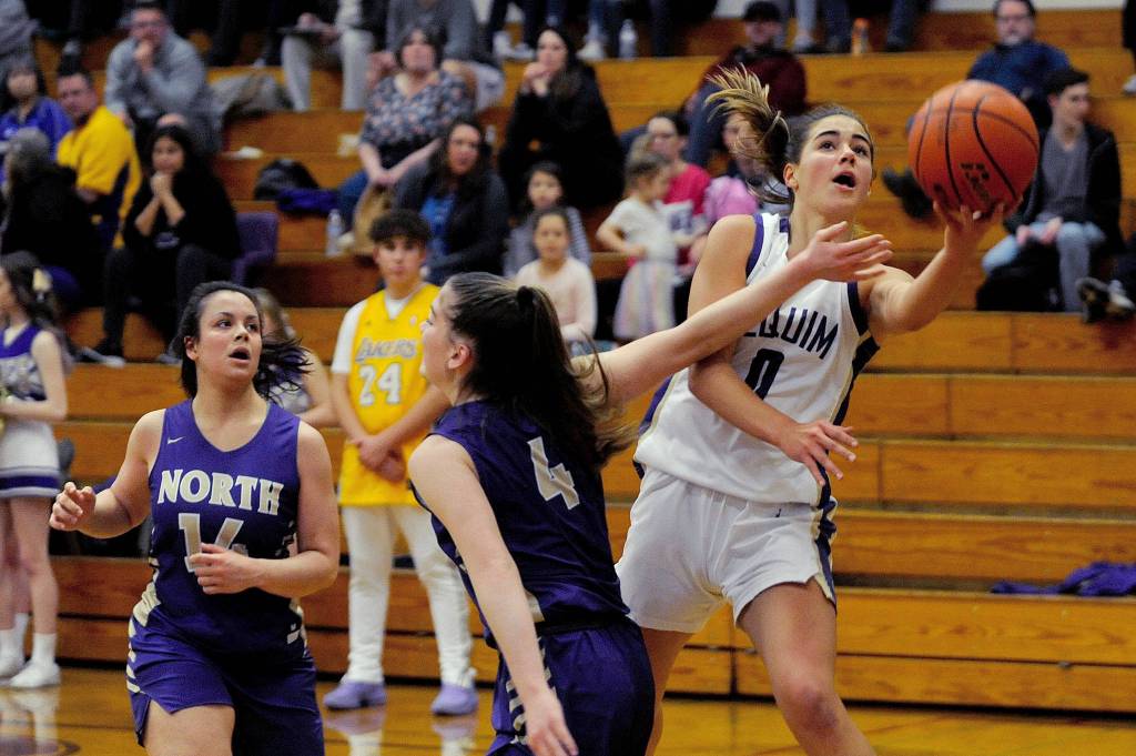 Sequim Wolves guard Hannah Bates (right) drives inside against North Kitsap Vikings guard Kamora McMillian during the second quarter of the Wolves 78-49 win over the Vikings on Jan. 31. Bates scored 16 points off the bench, and Wolves head coach Linsay Rapelje remarked after the game she was playing so well it was hard to take her off the court. Sequim Gazette photo by Conor Dowley                                Sequim Wolves post Hope Glasser (0) gets fouled by North Kitsap Vikings guard Sophia Baugh while shooting on a drive into the lane during the second quarter of the Wolves 78-49 win over the Vikings on Jan. 31. Sequim Gazette photo by Conor Dowley