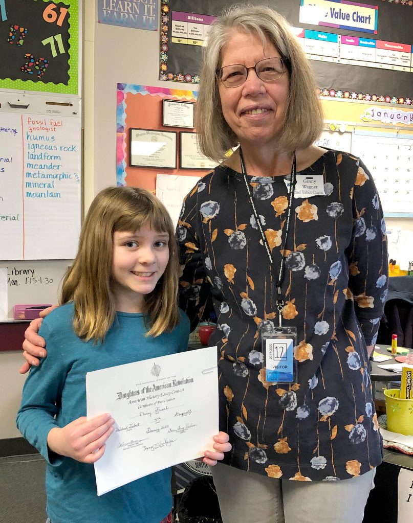 Greywolf Elementary School student Maisy French accepts a participation certificate from Viginia Wagner of the Daughters Of The American Revolution. Photo by Teresa Iversen