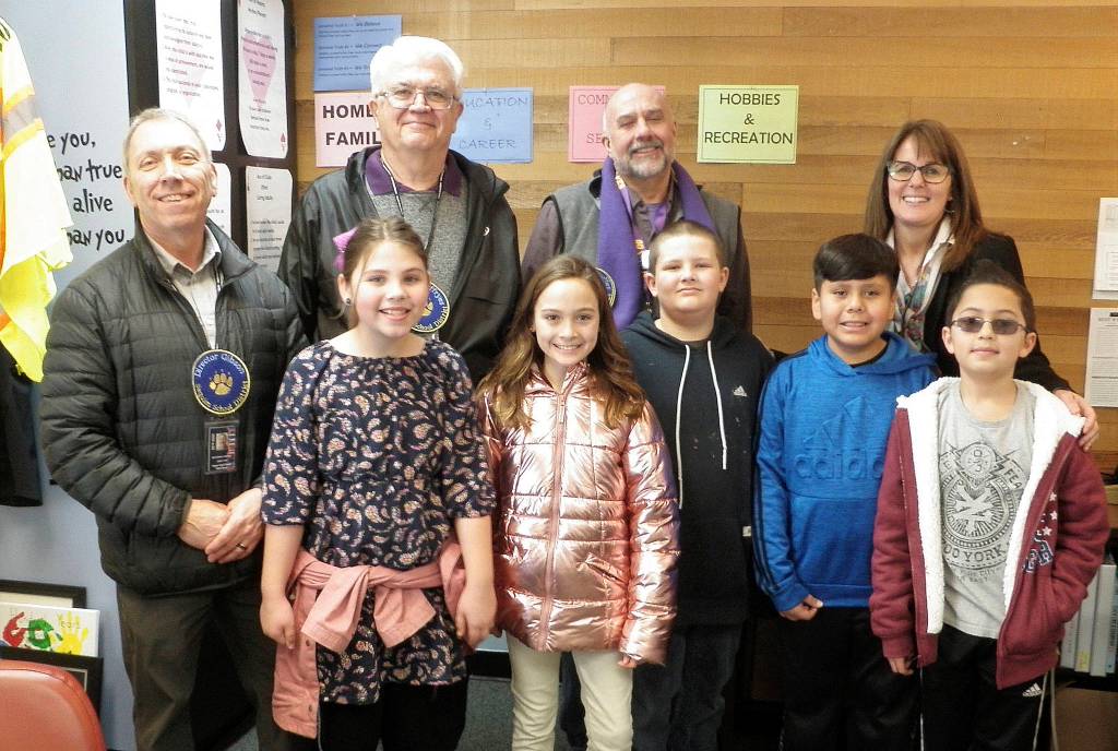 A group photo at the conclusion of the school tour included (front row, from left) student guides Olivia Knight, Genevieve Wakefield, Michael Wheeler, Domingo Pacheco and Ianson Klinger, as well as (back row, from left) board president Brandino Gibson, director Larry Jeffryes, director Jim Stoffer and principal Becky Stanton. The fourth-graders reported they had a blast taking the visiting dignitaries around campus. Photo by Patsene Dashiell