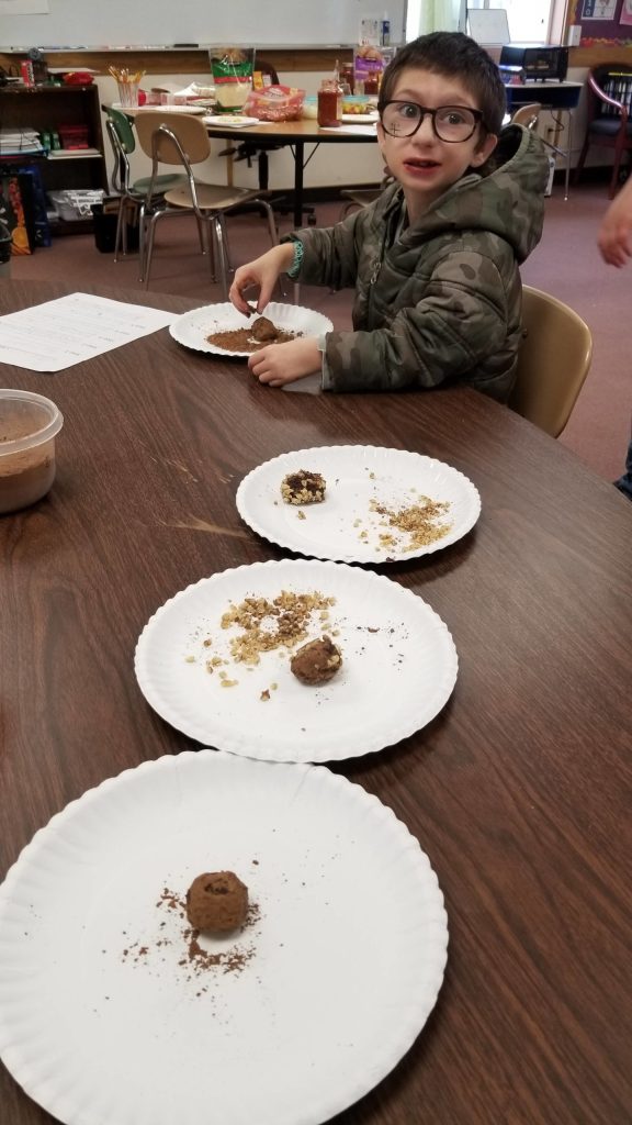 After watching an instructional video, James Bardin from Mike McCanns Life Skills class creates a chocolate truffle. Photo by Melissa Sagara