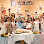 Third-graders in Robin Forrests class at Helen Haller Elementary School raise their glasses of fruit juice in salute to the culmination of their ancient Roman studies. Students were decked out in togas and laurels to simulate a Roman feast. Photo by Robin Forrest