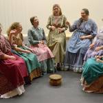 Actresses with Quilters ready quilts while singing Needles Eye to celebrate a mans 21st birthday on the frontier. Some of the women are family members while others are hoping to catch his eye, says director Richard Stephens. Sequim Gazette photo by Matthew Nash